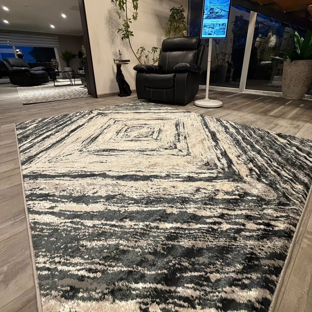 Alfombra Bangkok Onnas en living, marcos concéntricos en negro y crema que arman un rectángulo dentro de otro