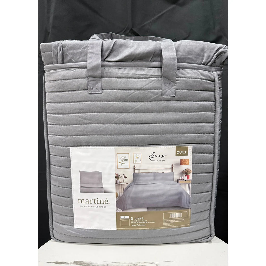 Quilt liso gris 2 plazas Martiné sobre cama, con fundas a juego