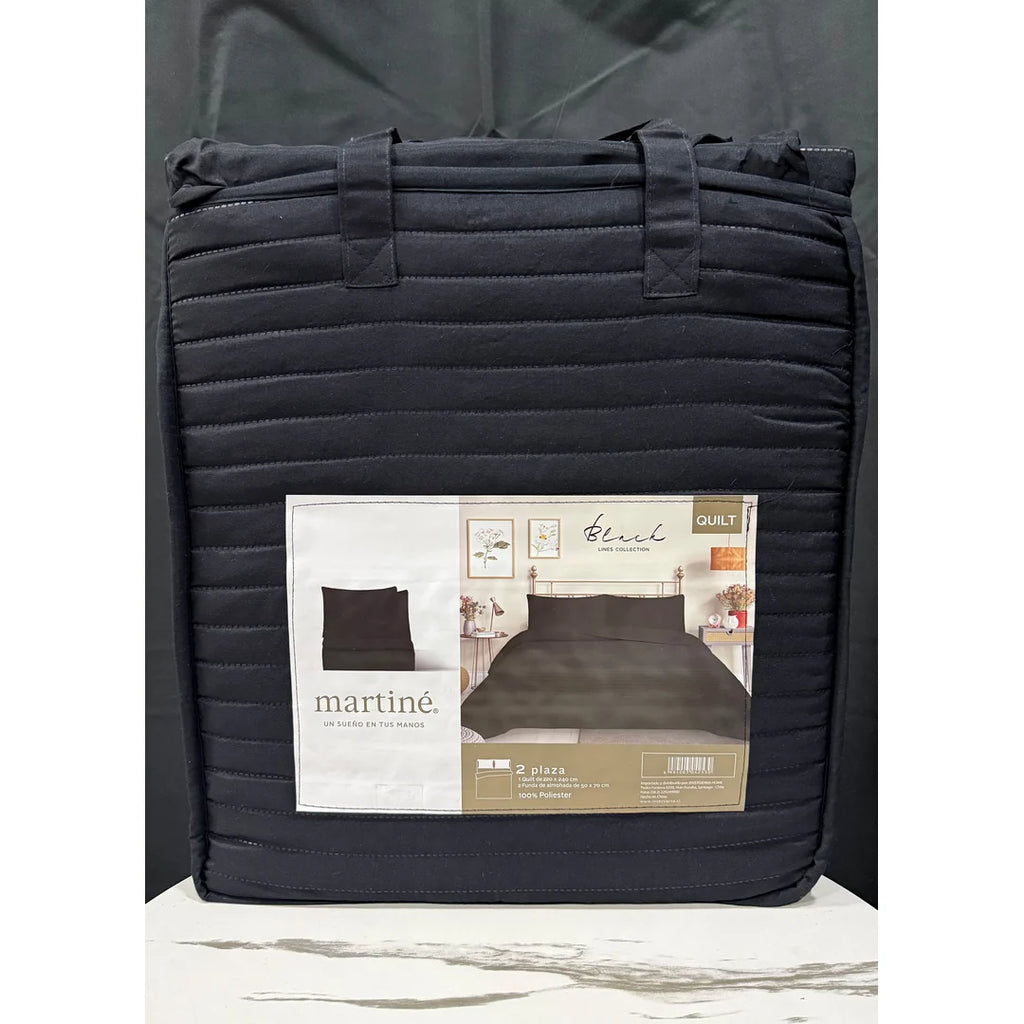 Quilt liso negro 2 plazas Martiné sobre cama, con fundas a juego